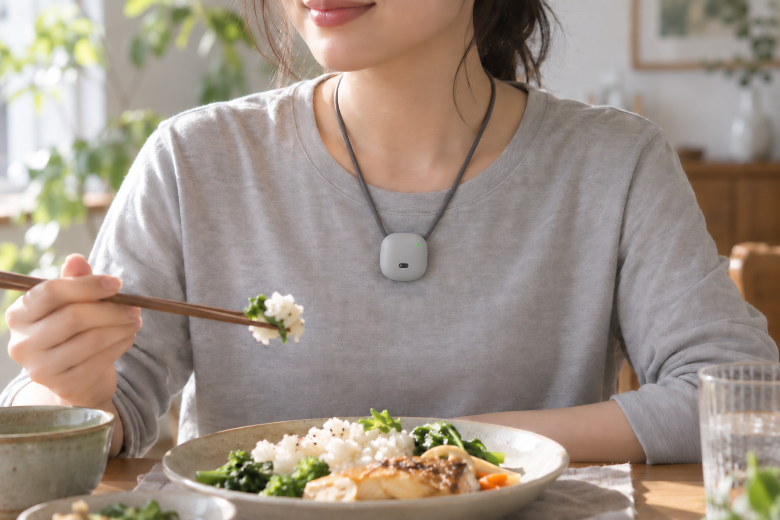 女性佩戴 Nutrimind 项链用餐，镜头朝前，右上角状态灯可见